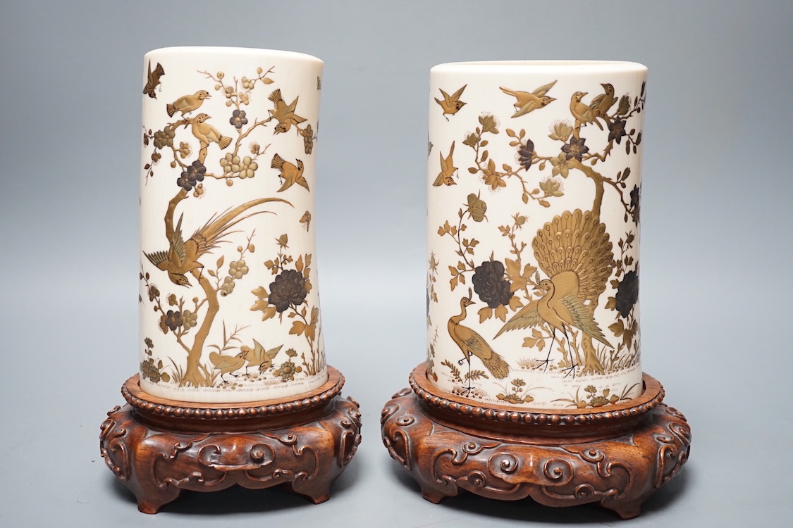 A graduated set of two Japanese gilt lacquered ivory vases, Meiji period, wood stands. Total height 21.5cm